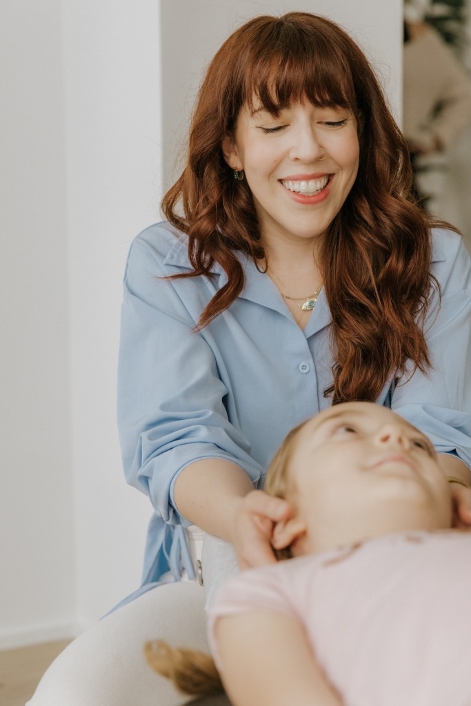 Dr. Courteney Werner providing pediatric chiropractic care for a child at Triada Health Ottawa.