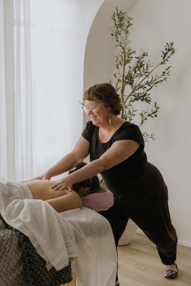 Carly Smith providing registered massage therapy treatment at Triada Health Ottawa