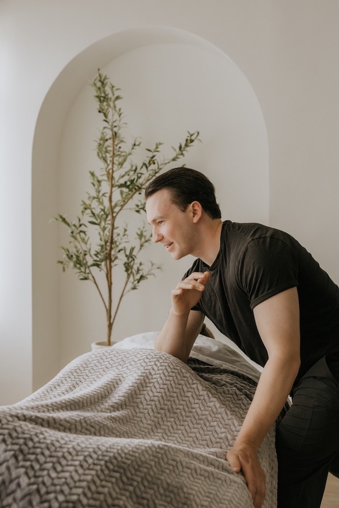 Devin Brown, Registered Massage Therapist at Triada Health Ottawa, providing deep tissue massage treatment for muscle tension, tmj,  and recovery.