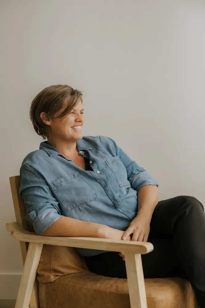 Tracey Crocker Acupuncturist and co-owner at Triada Health Ottawa sitting in the clinic