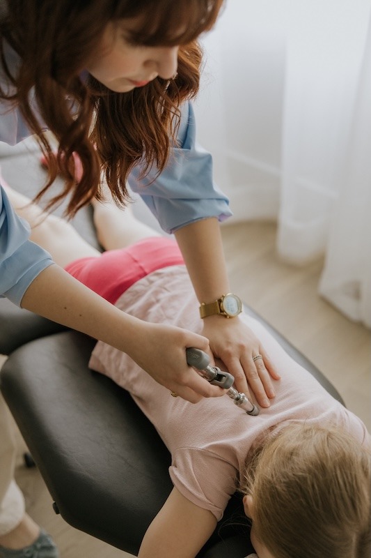 Dr. Courteney Werner assessing a young patient’s movement and posture in Ottawa
